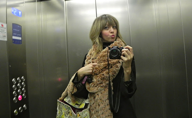 Lady fur taking photo with fur coat inside elevator