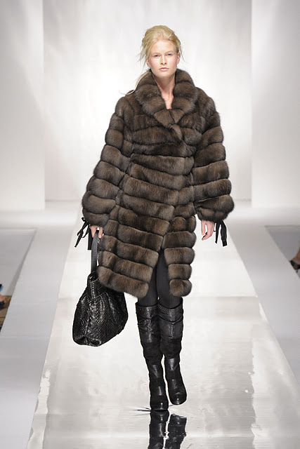 Woman wearing long brown fur coat